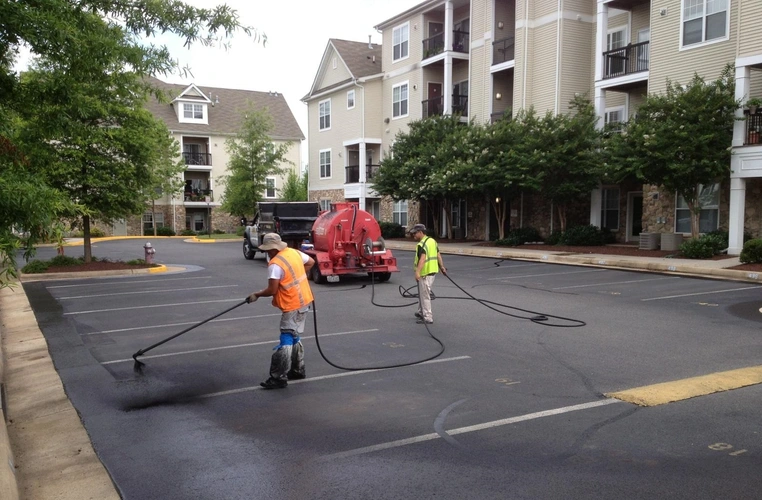 A crew doing sealcoating